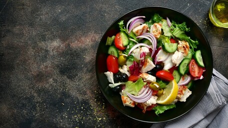 Grilled Romaine Salad with roasted vegetables and bread hummus