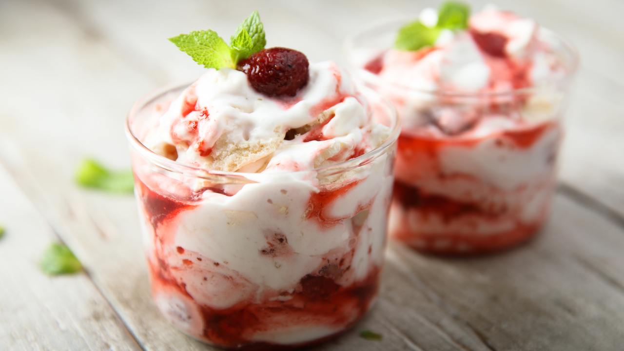 Jelly Base Eton Mess Pots with Fresh Fruit, Cream, Sponge Cake Pieces, and Raspberry Coulis