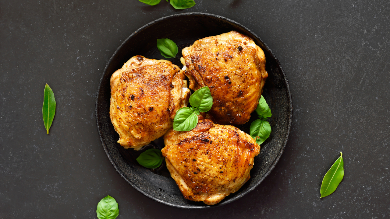 Roast chicken thigh with tomato, basil and butterbeans ragout