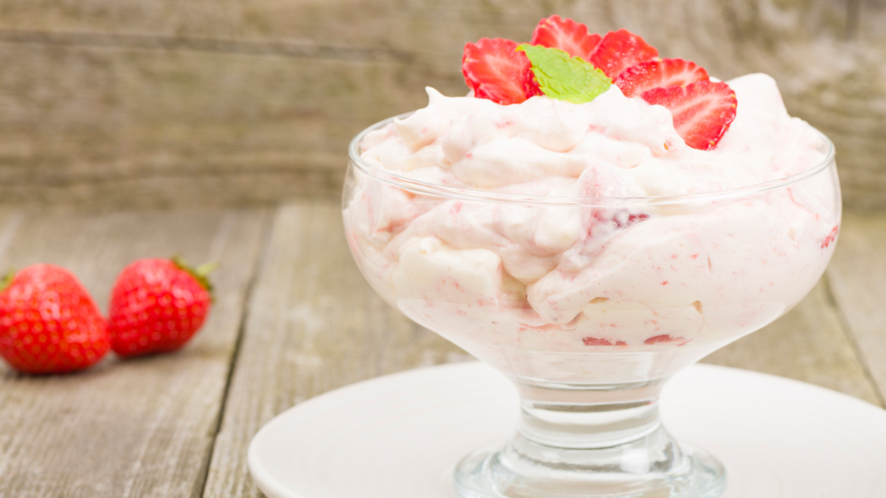 Strawberry Lemon Curd Eton Mess served with vanilla pod cream and topped with pomegranates