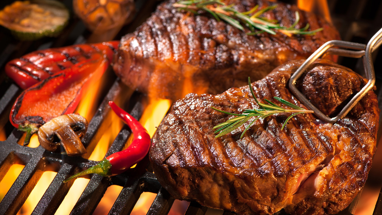 Prime rib-eye steak with chargrilled veggies and a summer salad